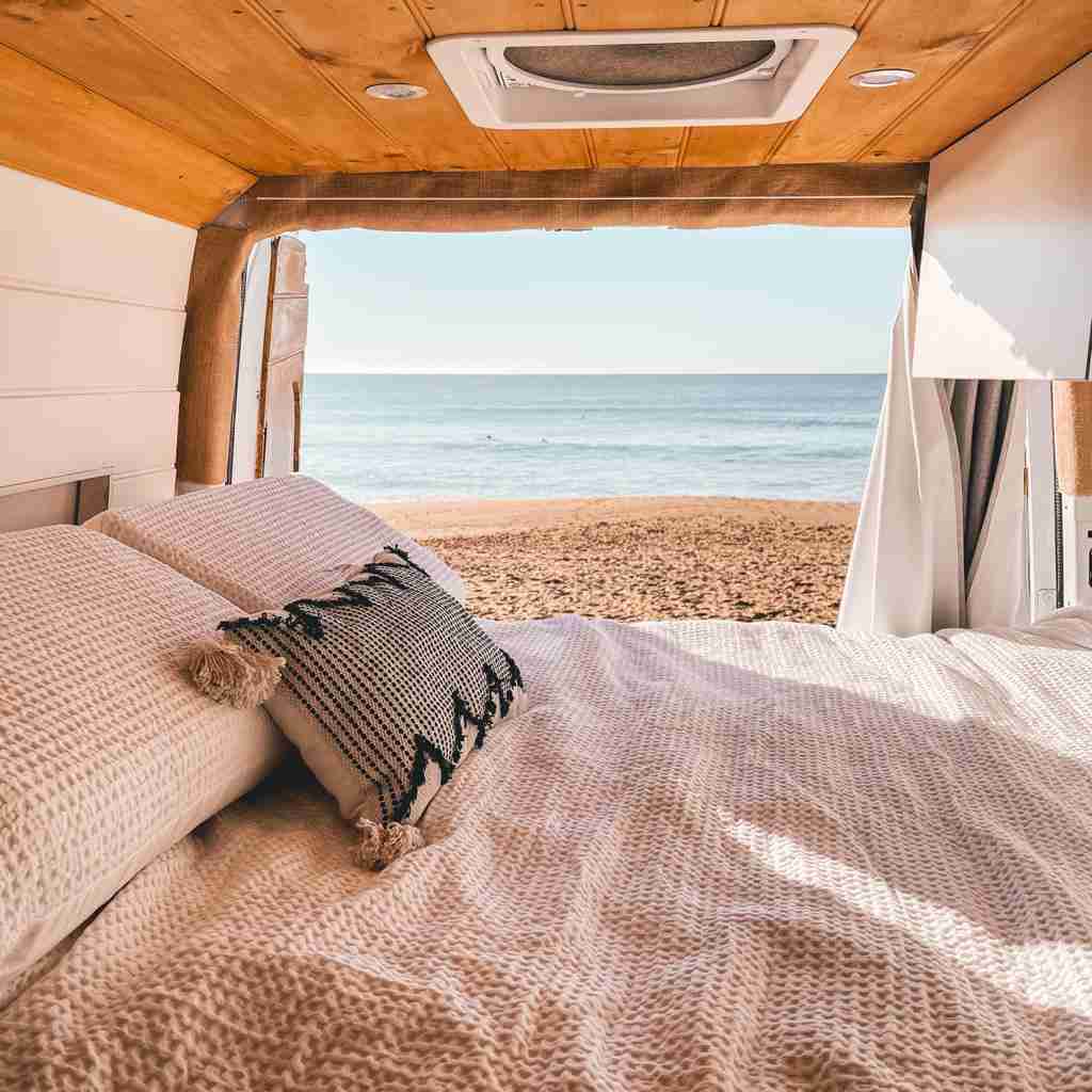 camper van roof vent with rear doors open to beach