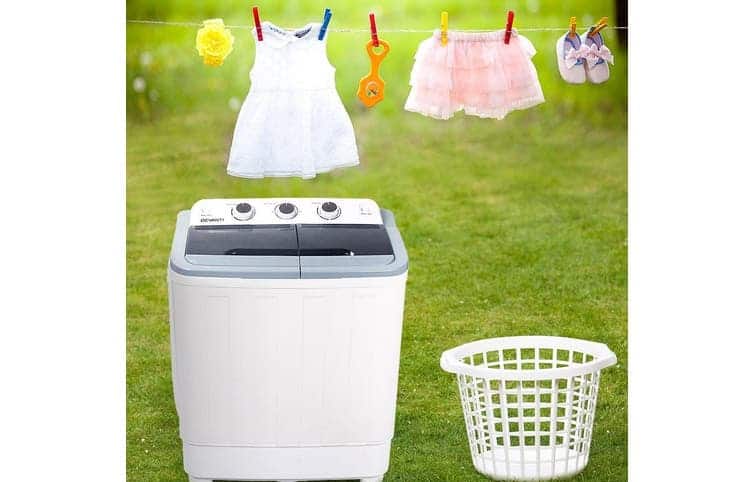 Devanti White 5kg Portable Top Load Washing Machine with clothes hanging in the background