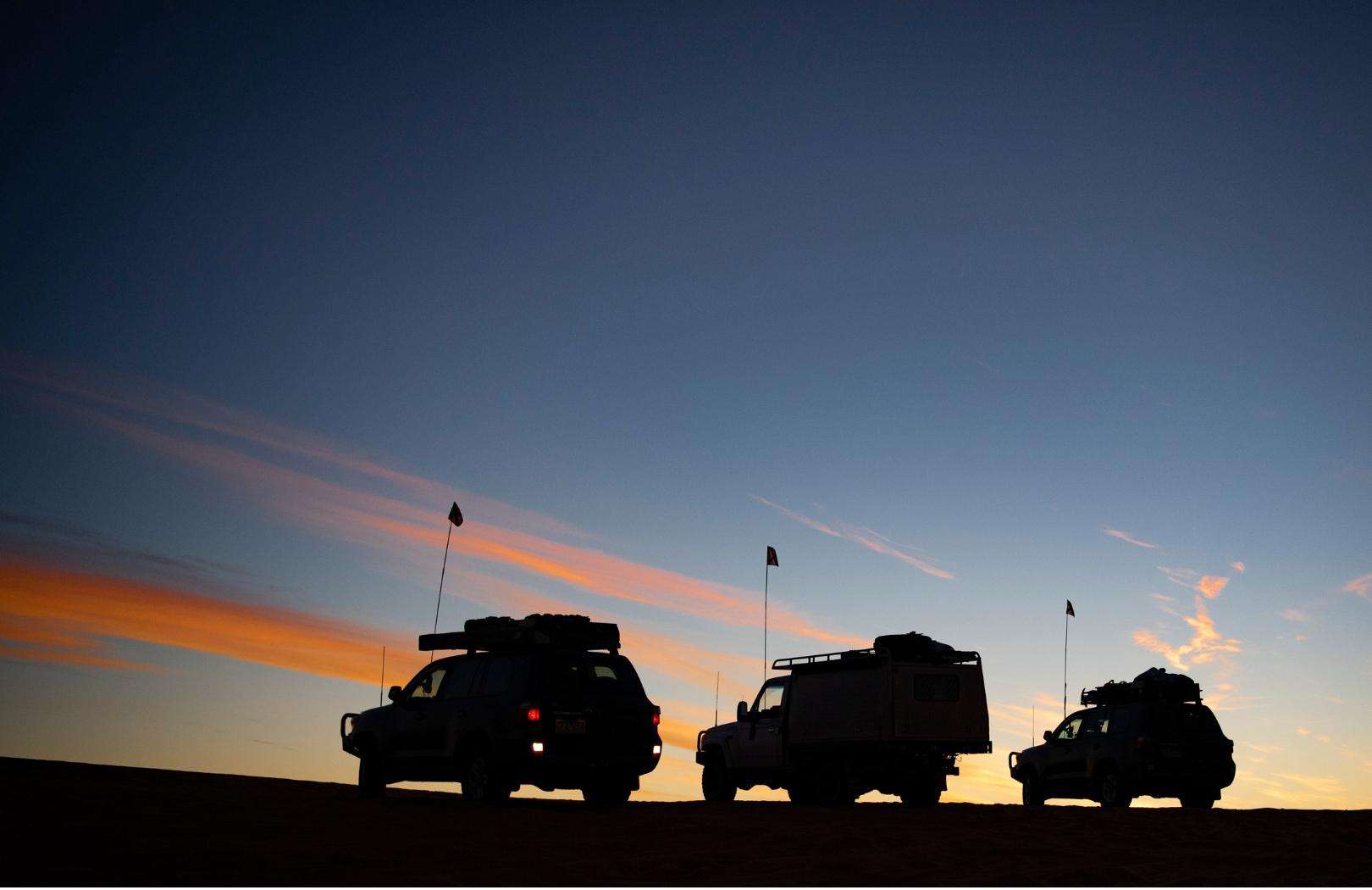 3 4wd cars watching a sunset