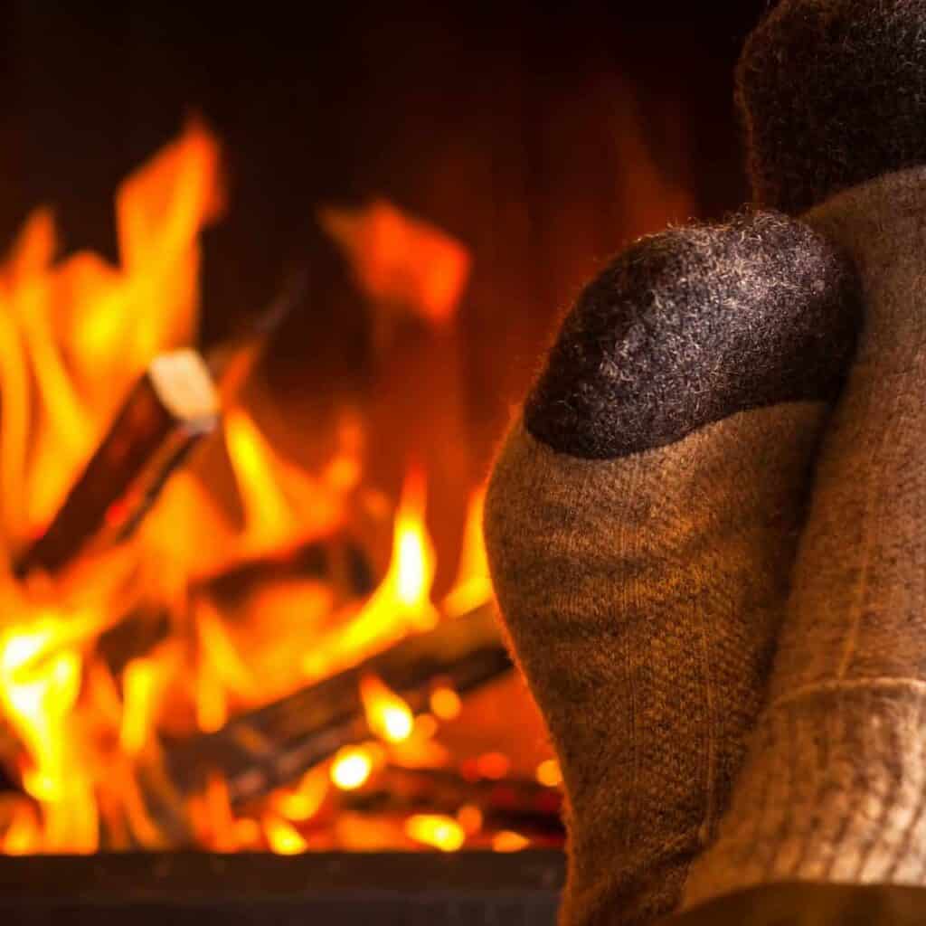 Feet with Socks on - in front of a wood fire