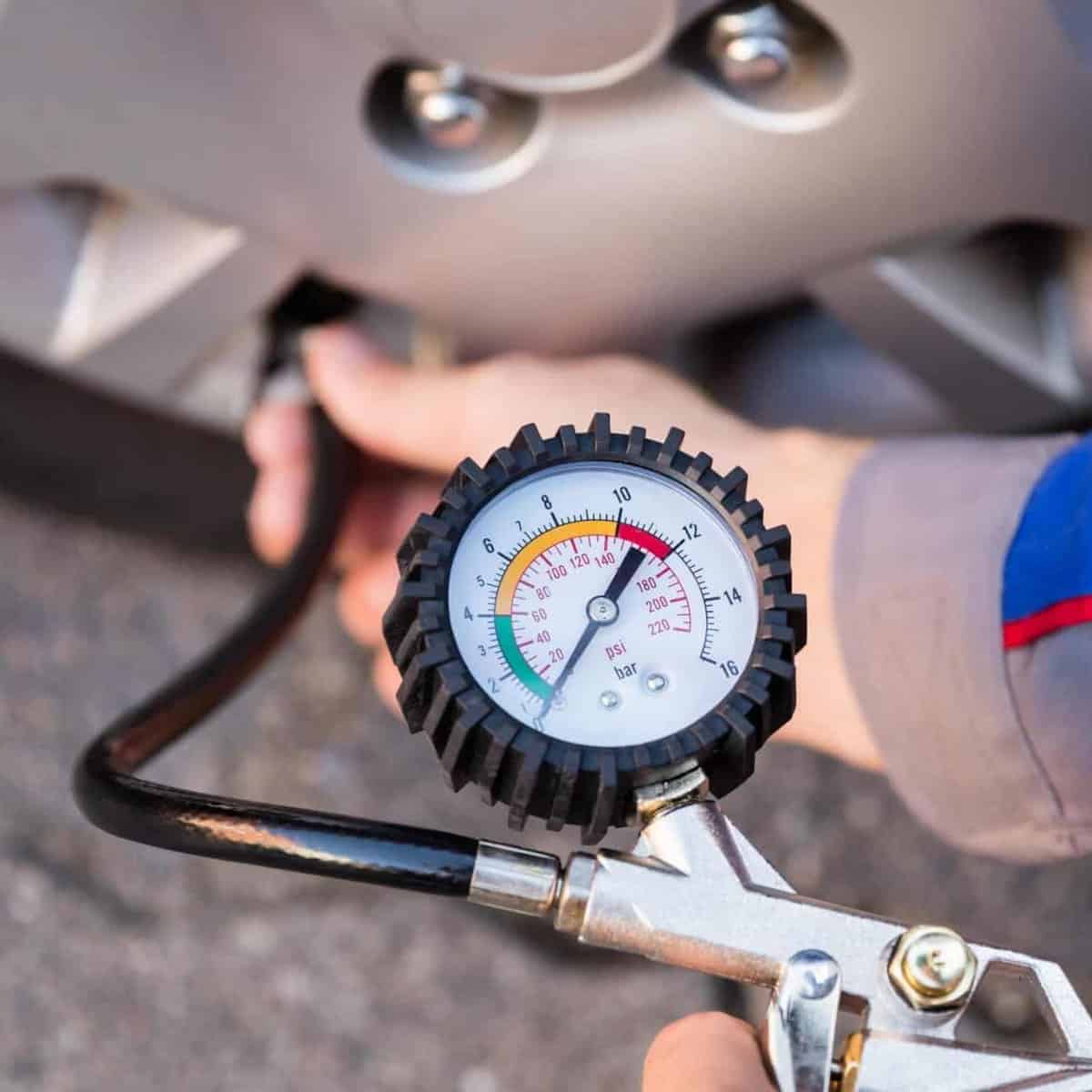 A man adding air to a tyre