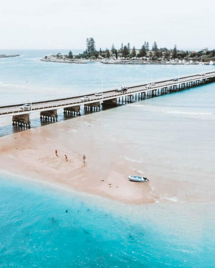 Drone shot over bridge and Wallis Lake 