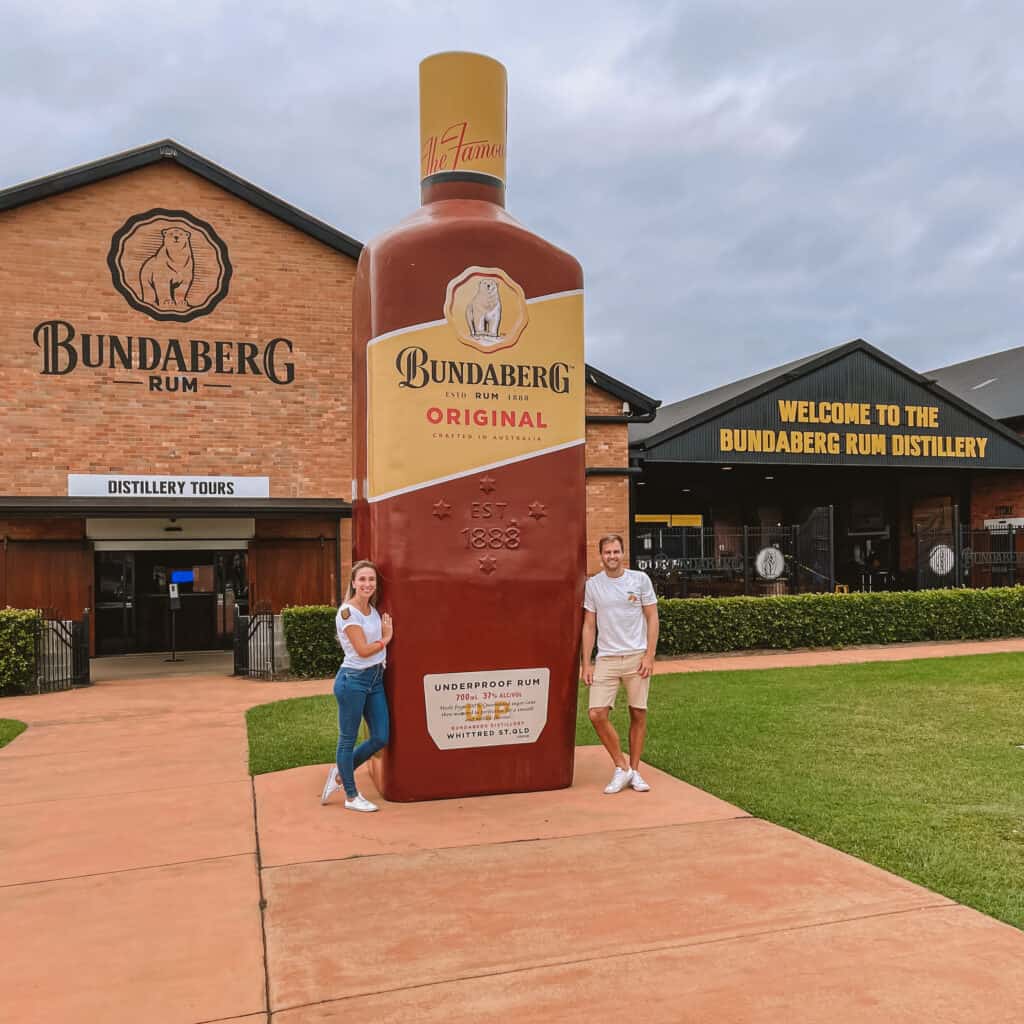 Wade and Dani outside with the big Bundaberg rum bottle
