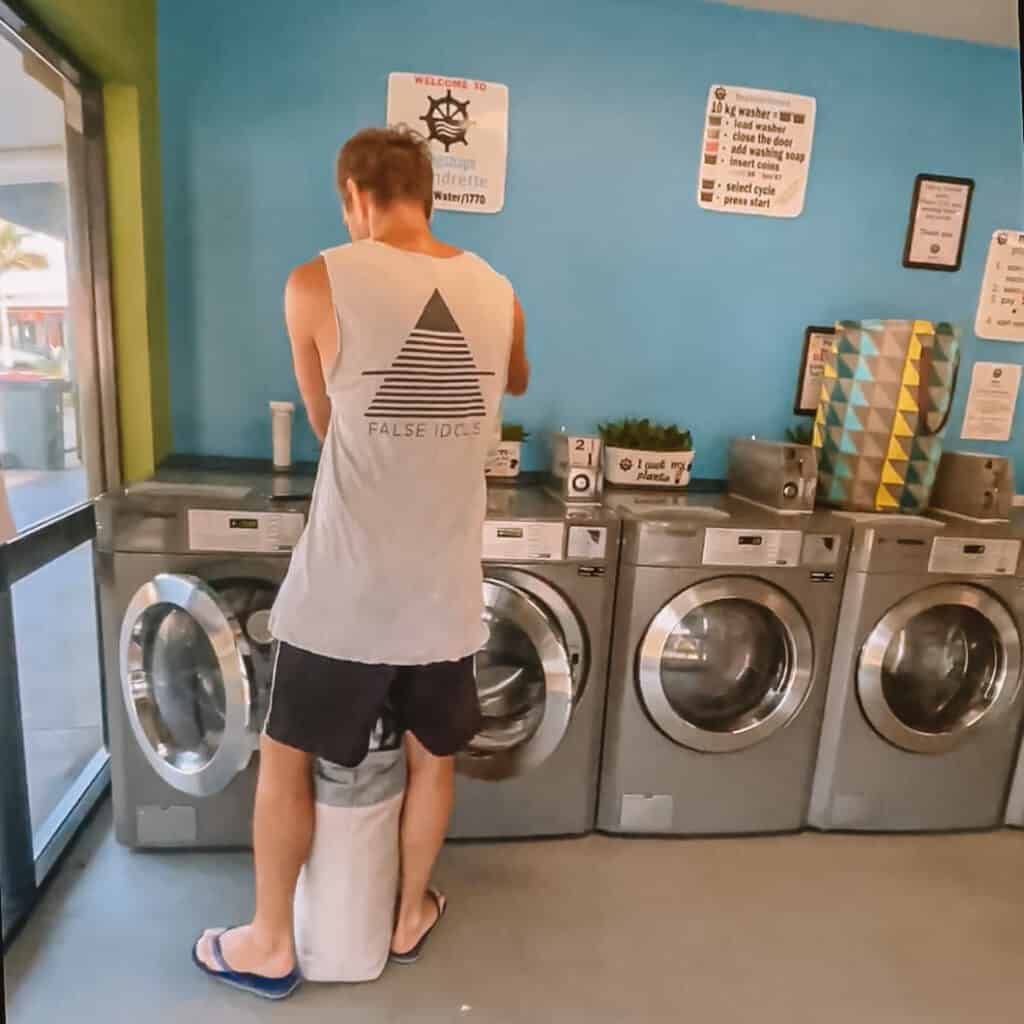 Wade in a laundromat doing washing