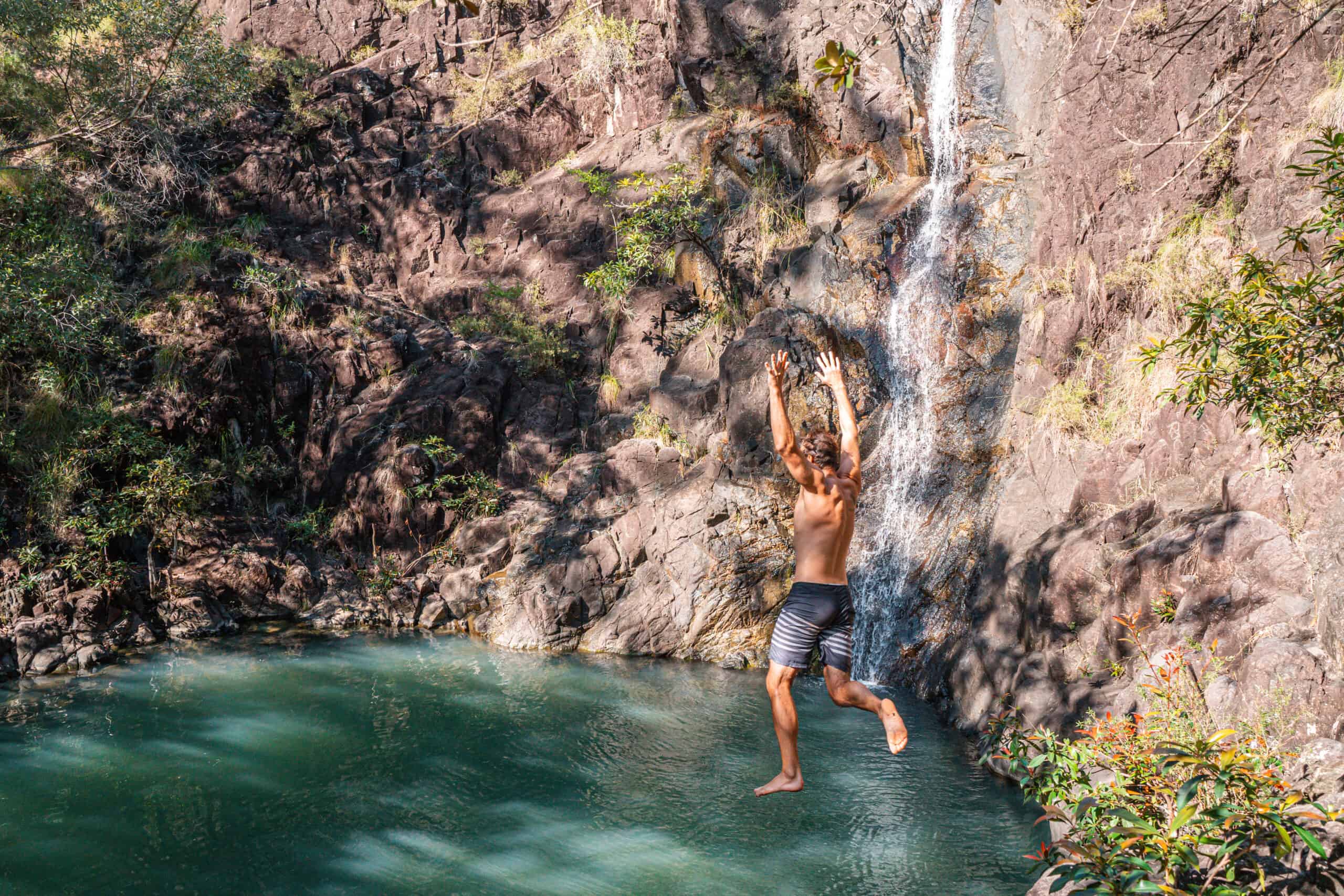 Wade jumping into Attie Creek Falls