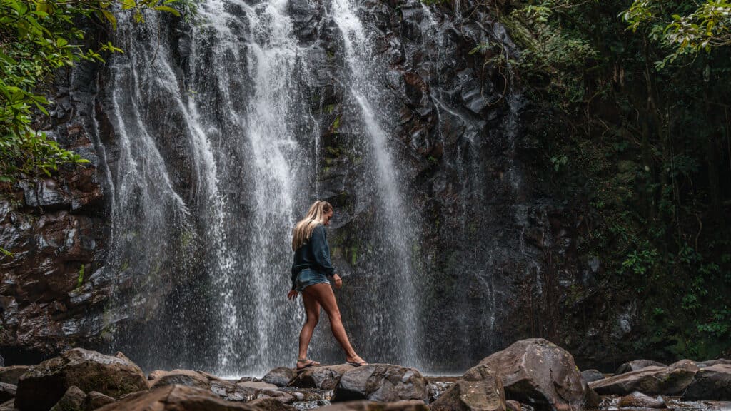 Dani walking along rocks at the bottom of Ellinjaa Falls