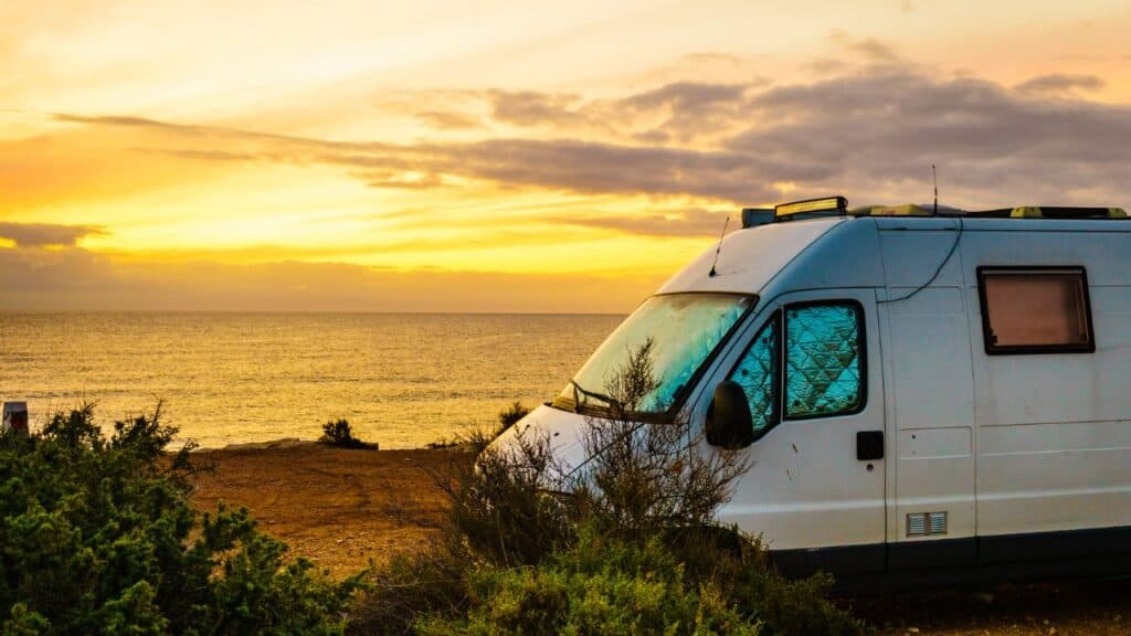 Campervan with sunset over the beach