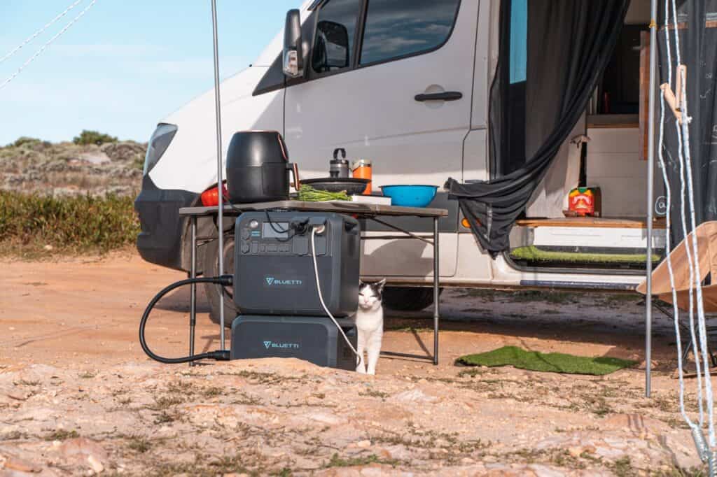 BLUETTI AC200MAX and B230 Combo set up outside a campervan ready for cooking