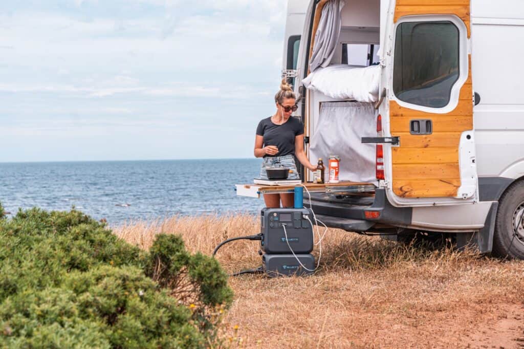 Cooking lunch at the back of a campervan with the BLUETTI AC200MAX and B230 Combo