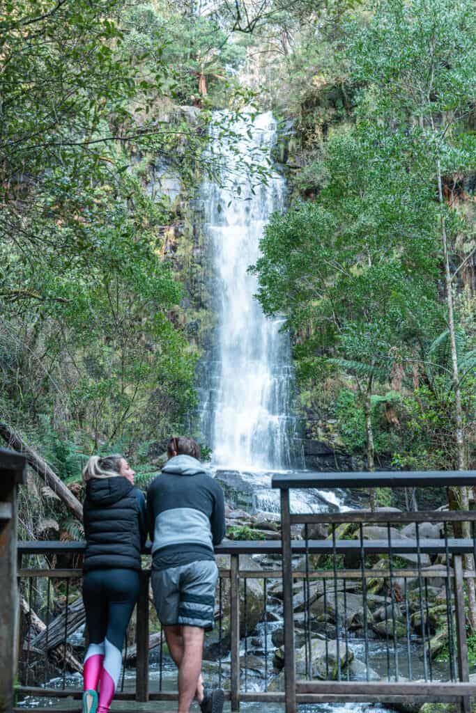 Wade and Dani standing on a platform looking at Erskine Falls in front of them
