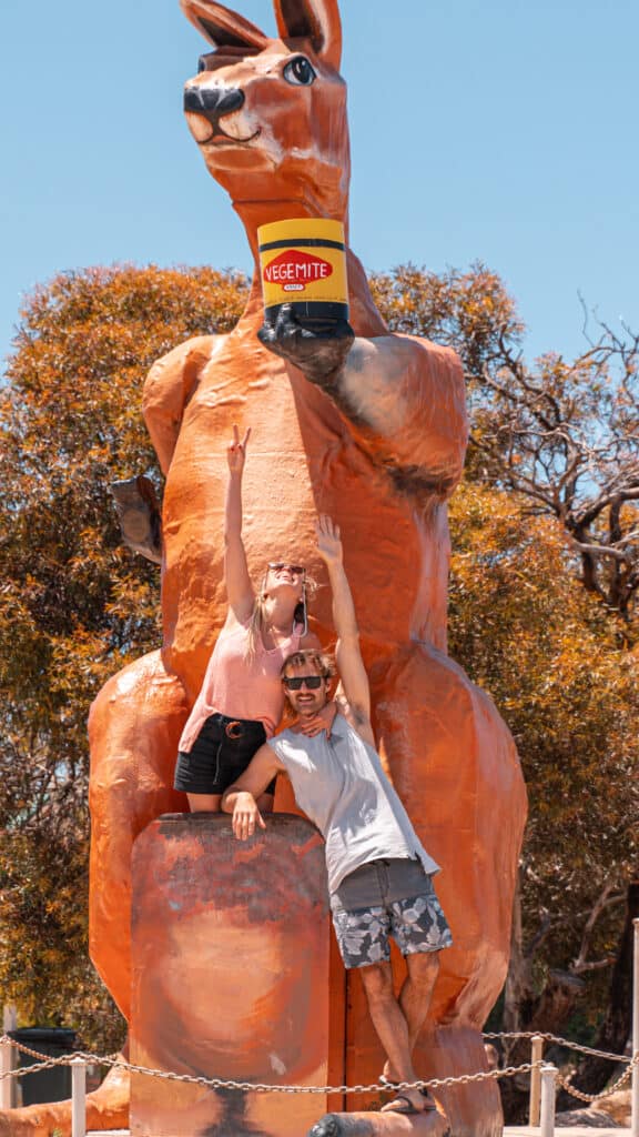 Dani and Wade at the giant kangaroo holding a Vegemite jar at the border of South Australia and Western Australia.