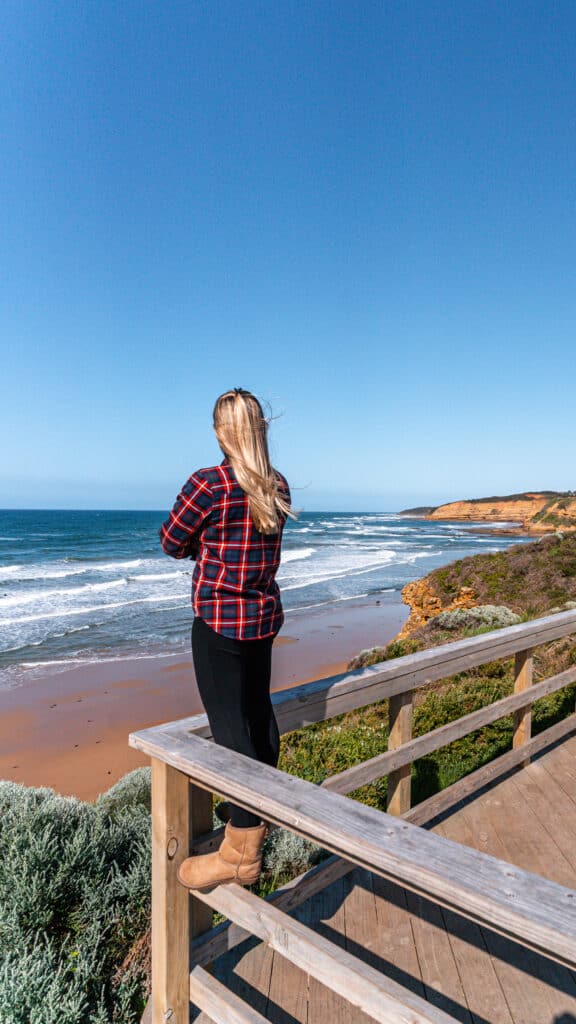 Dani standing on a wooden platform enjoying the views of Jan Juc Beach