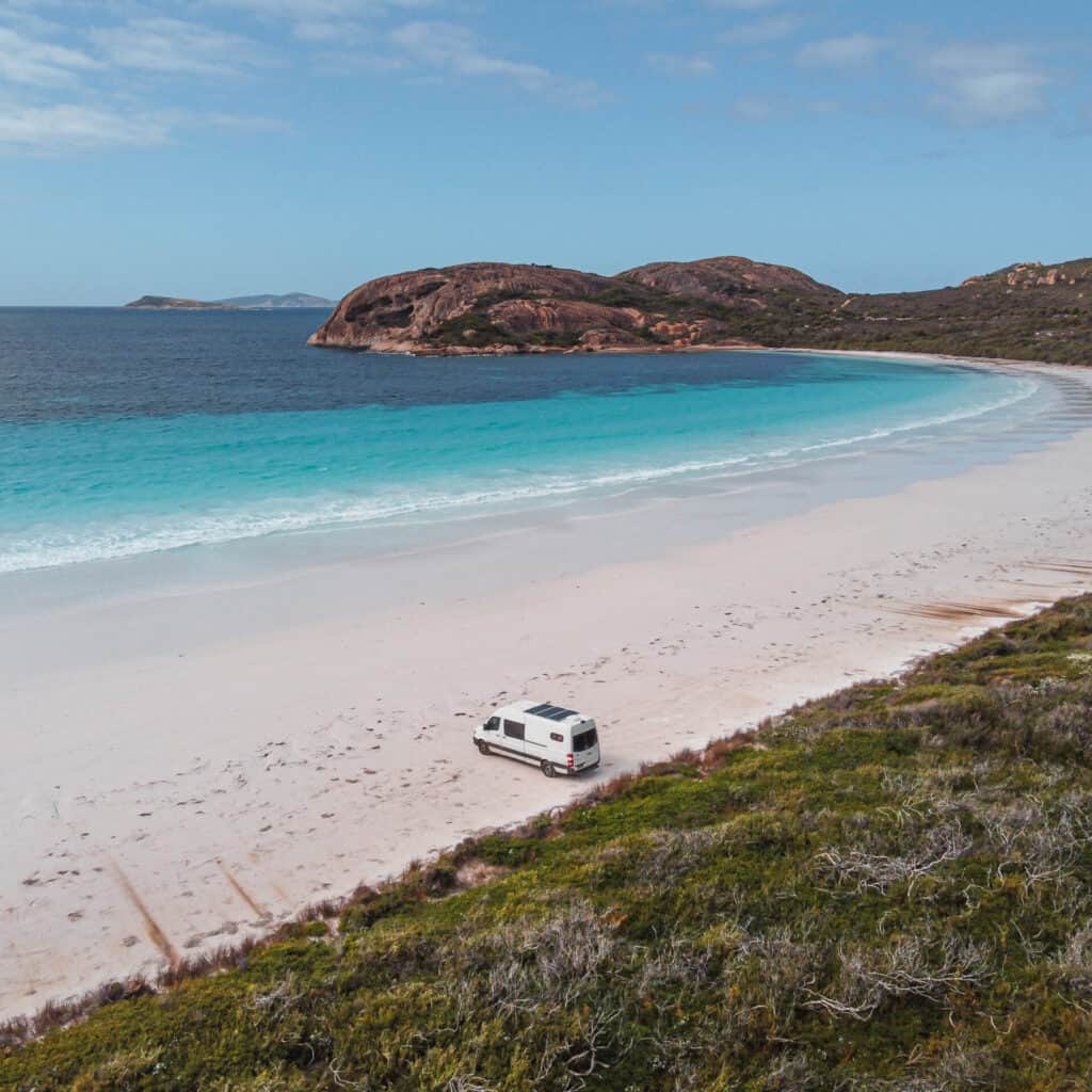 A van parked by the beach at Lucky Bay