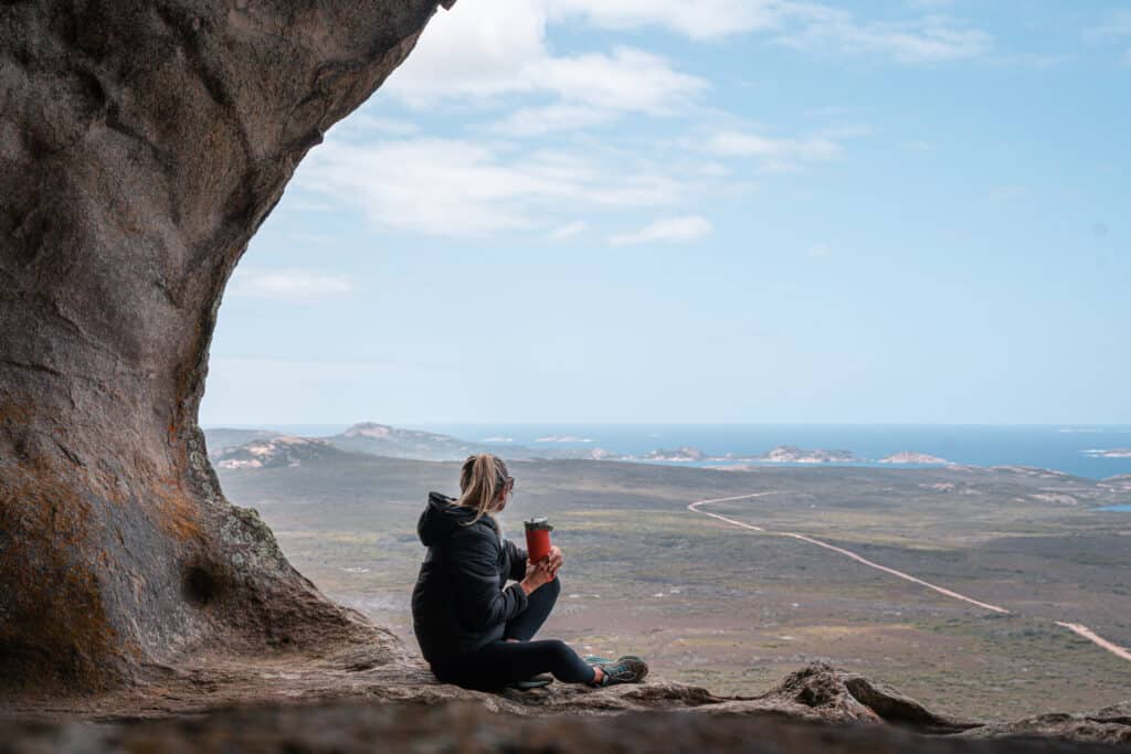 Dani sitting at the summit of Frenchman's Peak, you can see the whole Cape Le Grand National Park from the top. 