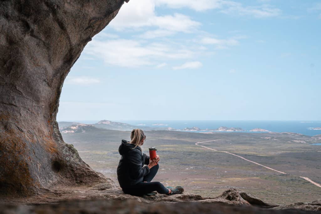 Dani sitting on a rock at the summit of Frenchman Peak. 