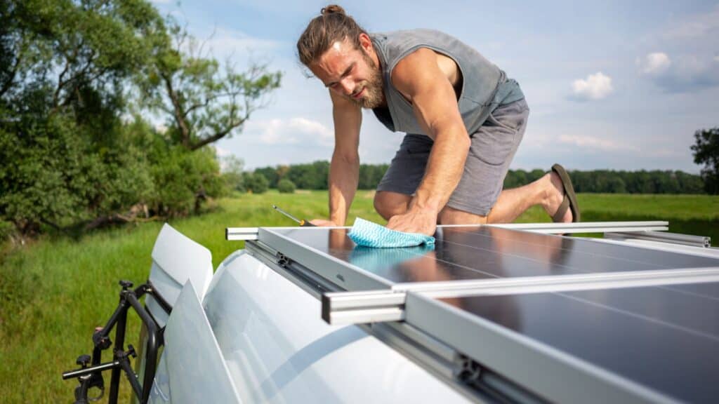 man Cleaning caravan solar panels