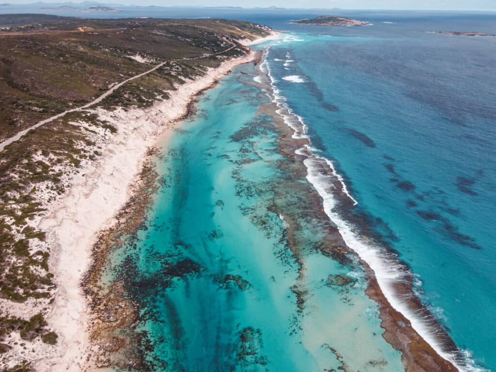 A drone image of Ten Mile Lagoon. The sand is very white and the water is crystal clear. 