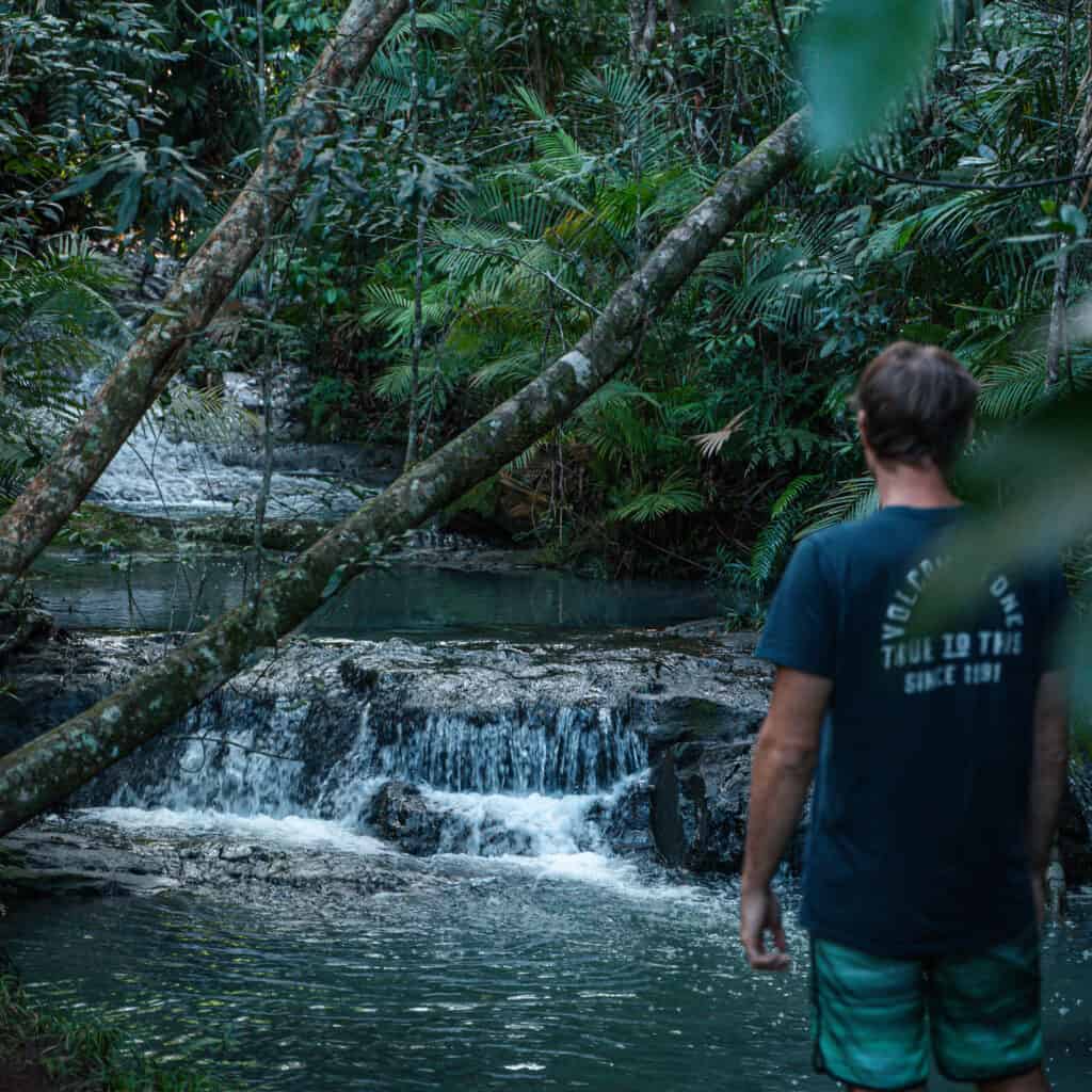 Wade looking at the natural rock pools that are formed on the way to Tully Gorge 