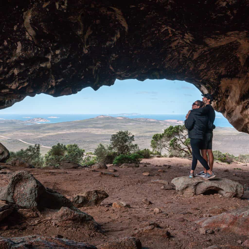 Wade and Dani hugging at the top of Frenchman Peak under a cave