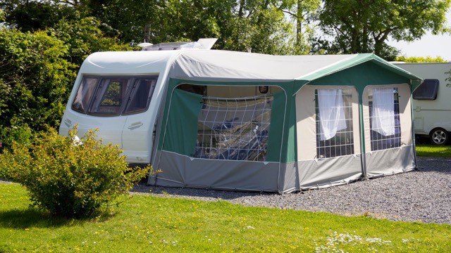 Caravan with awning and side sections