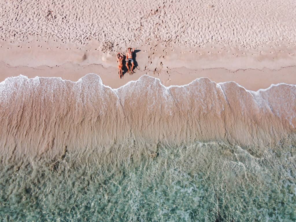 Wade and Dani laying on the beach in Margaret River