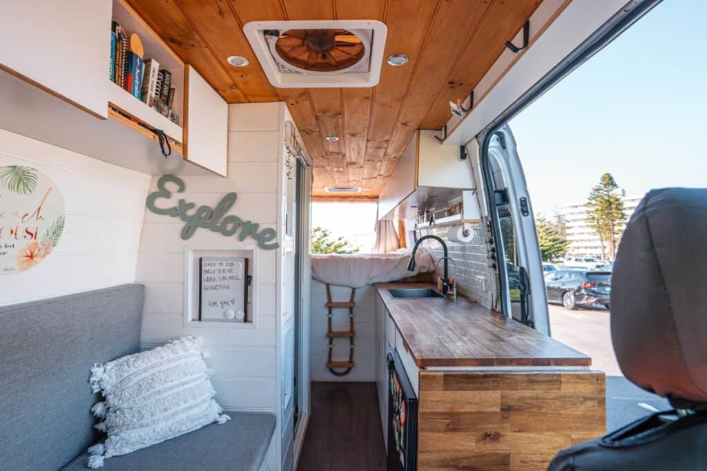 Inside our campervan showing the kitchen and bed area