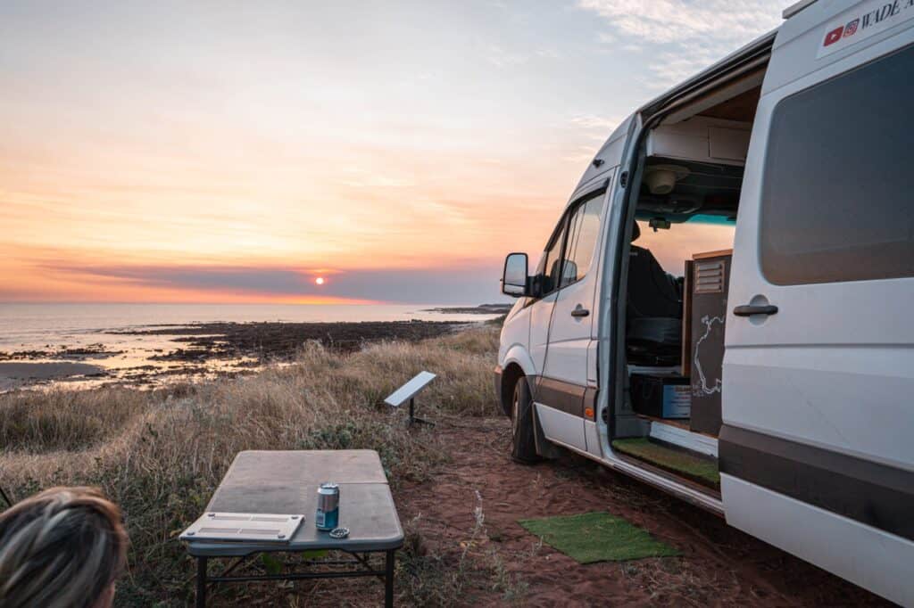 Mercedes Sprinter camper van and sunset at a beach camp