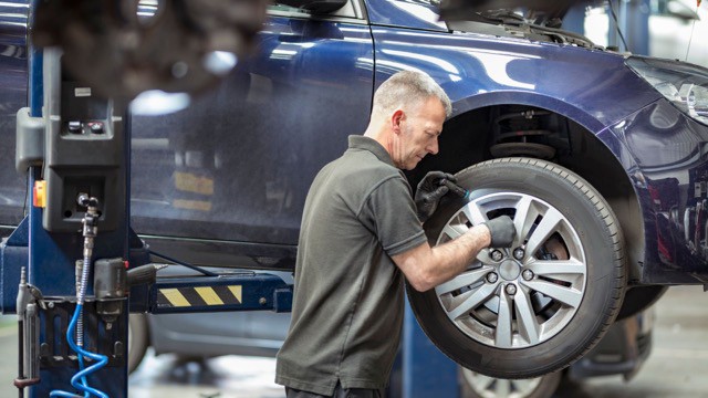 A man fixing a car tyre