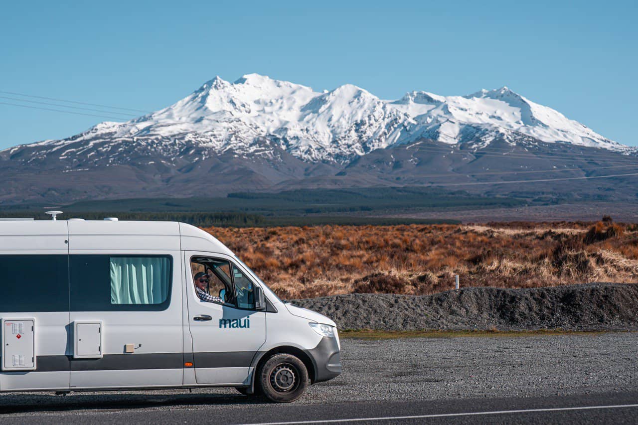 Camper van with snow capped mountain in NZ